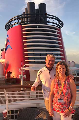 Agent Darcy and her husband posing on a Disney Cruise ship