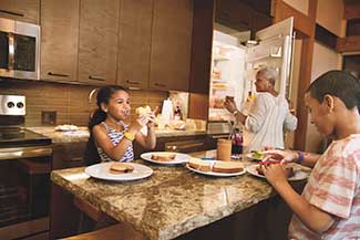 Family gathered in the kitchen at a Copper Creek Villa