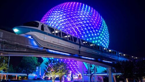 Monorail at night with Spaceship Earth in the background