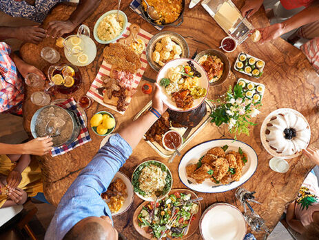 Birds-eye view of a family sharing dinner at Art Smith's Homecomin in Disney Springs