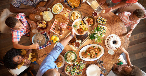 Birds-eye view of a family sharing dinner at Art Smith's Homecomin in Disney Springs