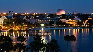 Aerial view of the Beach Club resort at night with Epcot in the distance