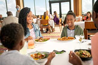 A family enjoying their meal at California Grille at Disney's Contemporary Resort