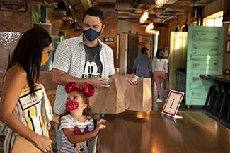 Family picking up their food order at a counter-service location