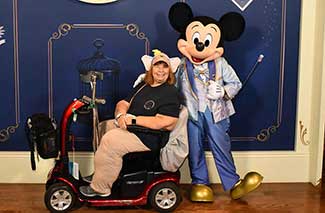 Mickey Mouse standing next to MVT Agent Carol on her ECV