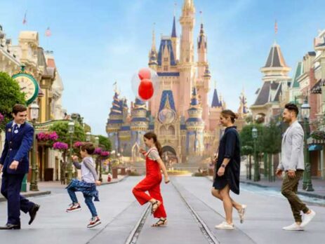 A Disney VIP tour group crossing Main Street USA with Cinderella Castle in background