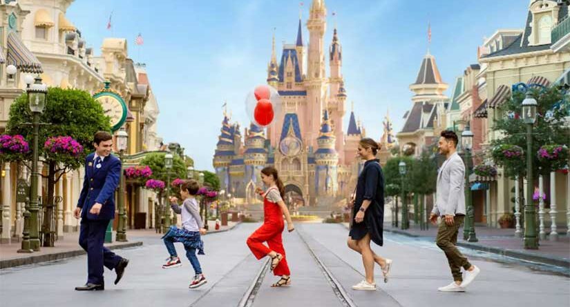 A Disney VIP tour group crossing Main Street USA with Cinderella Castle in background