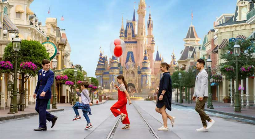 A Disney VIP tour group crossing Main Street USA with Cinderella Castle in background