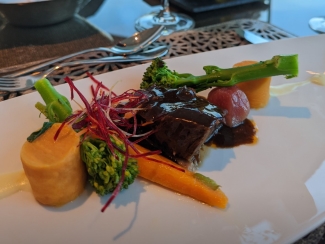 elegantly plated dinner on an Adventures by Disney river cruise